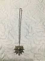 Full view of necklace laid flat showing entire chain and pendant