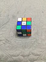 Cube front and top faces, showing logo on white centre