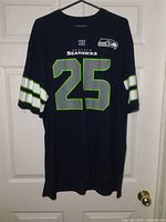 Front view of navy Seattle Seahawks #25 jersey on hanger