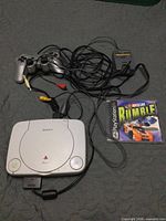 Top view of console, cords, controller, memory card and game