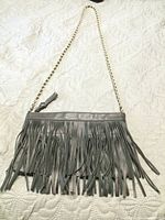 Front view showing fringe detail and chain strap