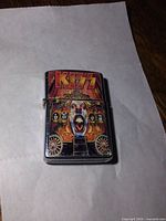 Front view of lighter closed showing KISS artwork