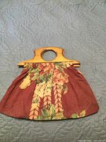 Front view of floral fabric purse with wooden handle