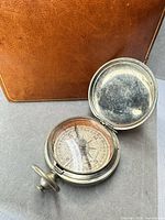 Compass open displaying dial, needle, degree scale and wear