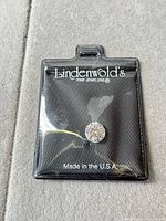 Front view of Lindenwold's packaging with loose cubic zirconia displayed
