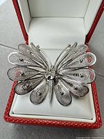 Front view of sterling butterfly filigree brooch in box