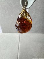 Front view amber pendant gold-tone cap