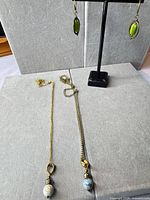 Full view of two necklaces and earrings on display