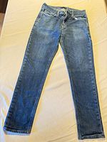 Full view of jeans front side laid flat