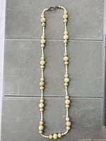 Full view of necklace laid flat showing overall length and bead arrangement