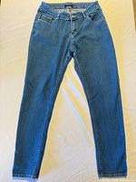 Full view of front of jeans laid flat