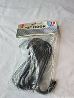 Front view of sealed package showing black S hooks and header card
