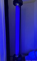 Lamp vertical and lit showing UV tube