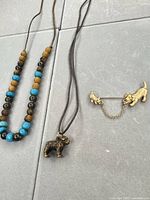 Overall view showing necklace, dog pendant and brooch