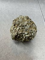 Front view of brassy gold metallic mineral specimen