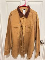 Full front view of jacket hung on door