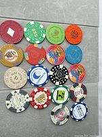 Full group of 17 mixed casino poker chips laid out