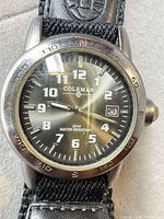 Close-up of watch face showing dial, bezel, and case wear