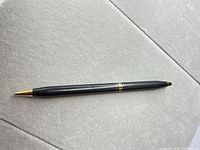 Full view of black Cross mechanical pencil with gold tip and trim