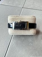 Front view of DKNY wrist watch on display pillow