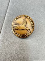 Obverse showing Ducks Unlimited Cinnamon Teal design and 2014 Sponsor text