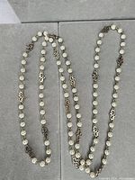 Full view of long faux pearl station necklace