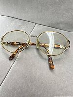 Front view of Fendi round eyeglass frames showing gold rims and tortoiseshell temples
