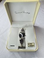 Watch in open French Laundry box showing exterior