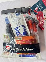 Front view of sealed GetReadyNow emergency kit showing contents