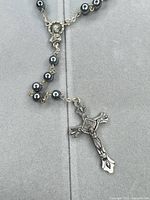 Close-up of center medal, beads and crucifix showing design and metal tone