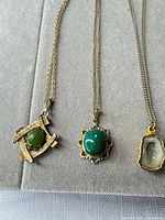 Front view of three necklaces with pendants