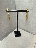 Full view of both earrings on stand