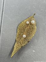 Front view showing full leaf brooch with pearls