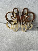 Front view showing gold-tone monogram design