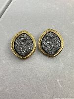 Front view of both earrings showing gold-tone textured border and silver gunmetal centers