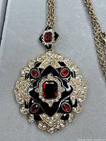 front view of pendant showing design, stones and enamel