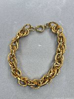 Full view of gold-tone textured oval link bracelet