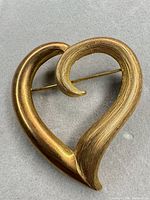 Front view of heart swirl brooch