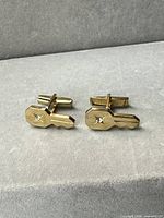 Front view of both key-shaped cufflinks showing rhinestone accents