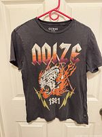 Full front view of Guess graphic T-shirt on hanger