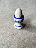 ceramic egg cup with wooden egg front view
