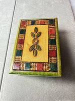 Top view showing carved flower motif and color-block border