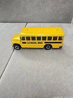 Side view of yellow Hot Wheels school bus toy