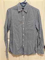 Full front view of J.Crew gingham shirt on hanger