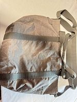 Full view of Kipling taupe nylon tote showing body, straps and wear
