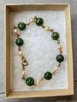 Bracelet in box showing alternating jade beads and pearls