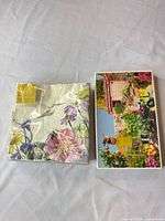 Packaged Lenox napkins beside boxed Postcarden kit