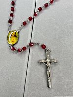 Close-up of crucifix and some red beads