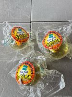 Three sealed capsule toys with Pokémon stickers visible