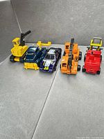 All five toy vehicles lined up
